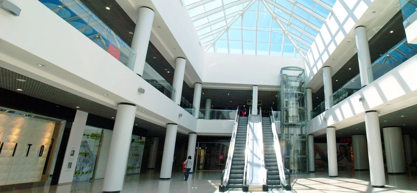 City Center: the shopping atrium, glazed roof and escalators. Retained company-portfolio photograph.