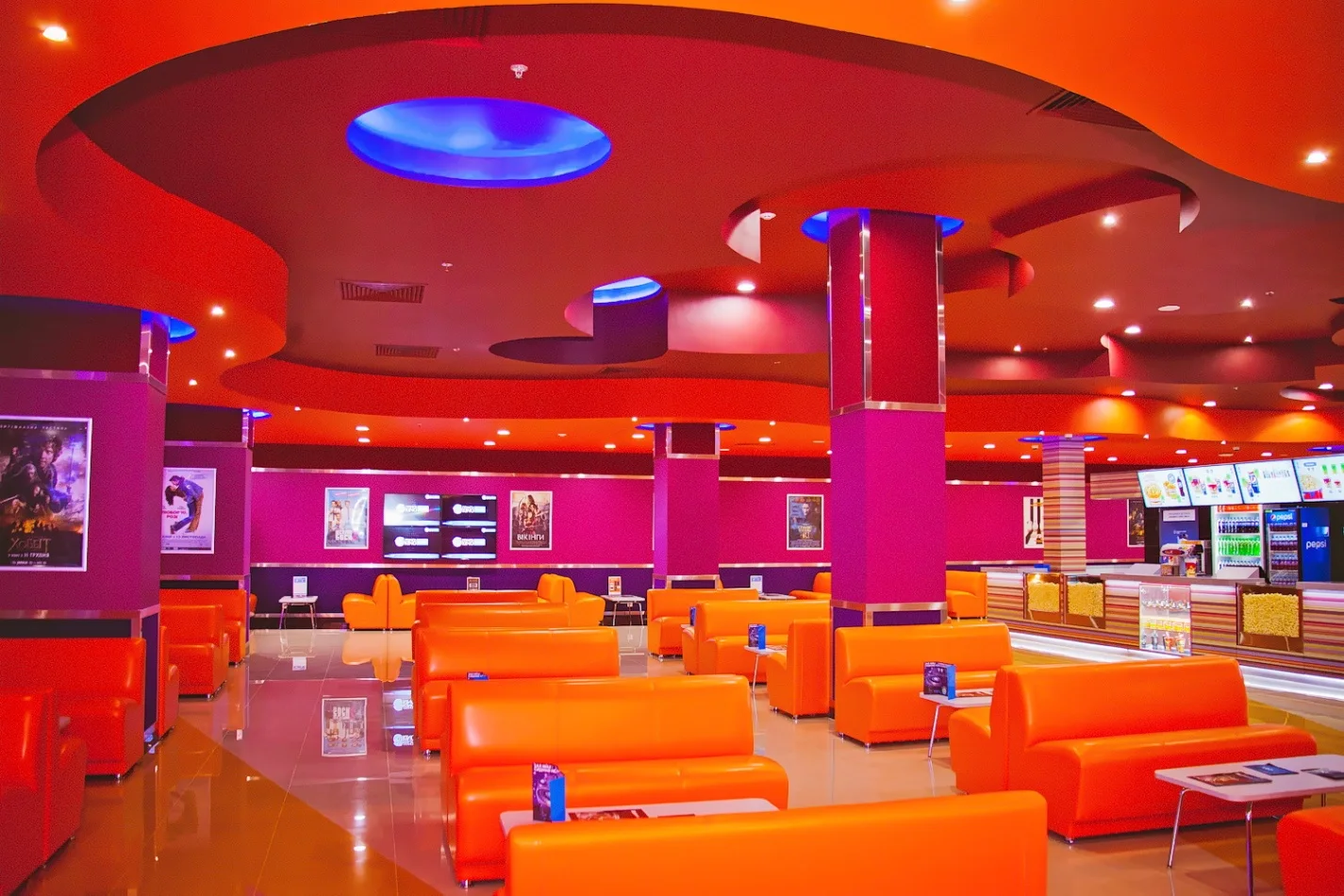 City Center: cinema foyer, ticket counters and seating. Retained company-portfolio photograph.