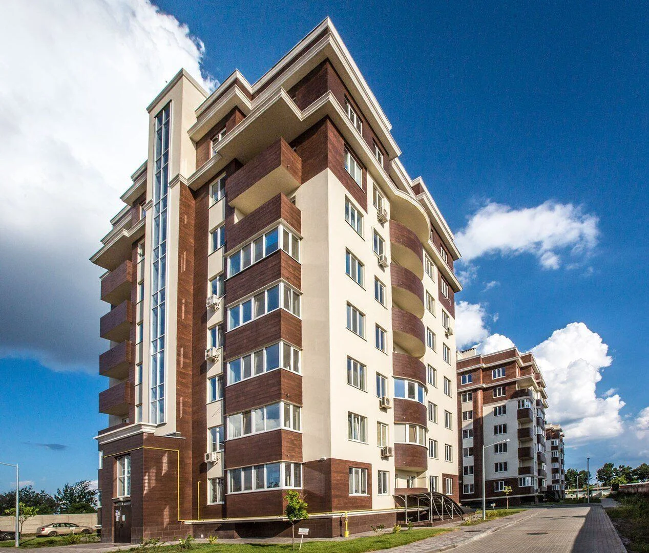 Golden Era — completed residential façade and balcony glazing. FES project photograph.