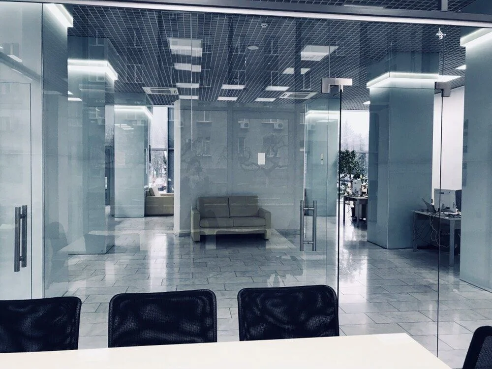 Public reception office: glass partitions enclosing the workspaces. FES project photograph.