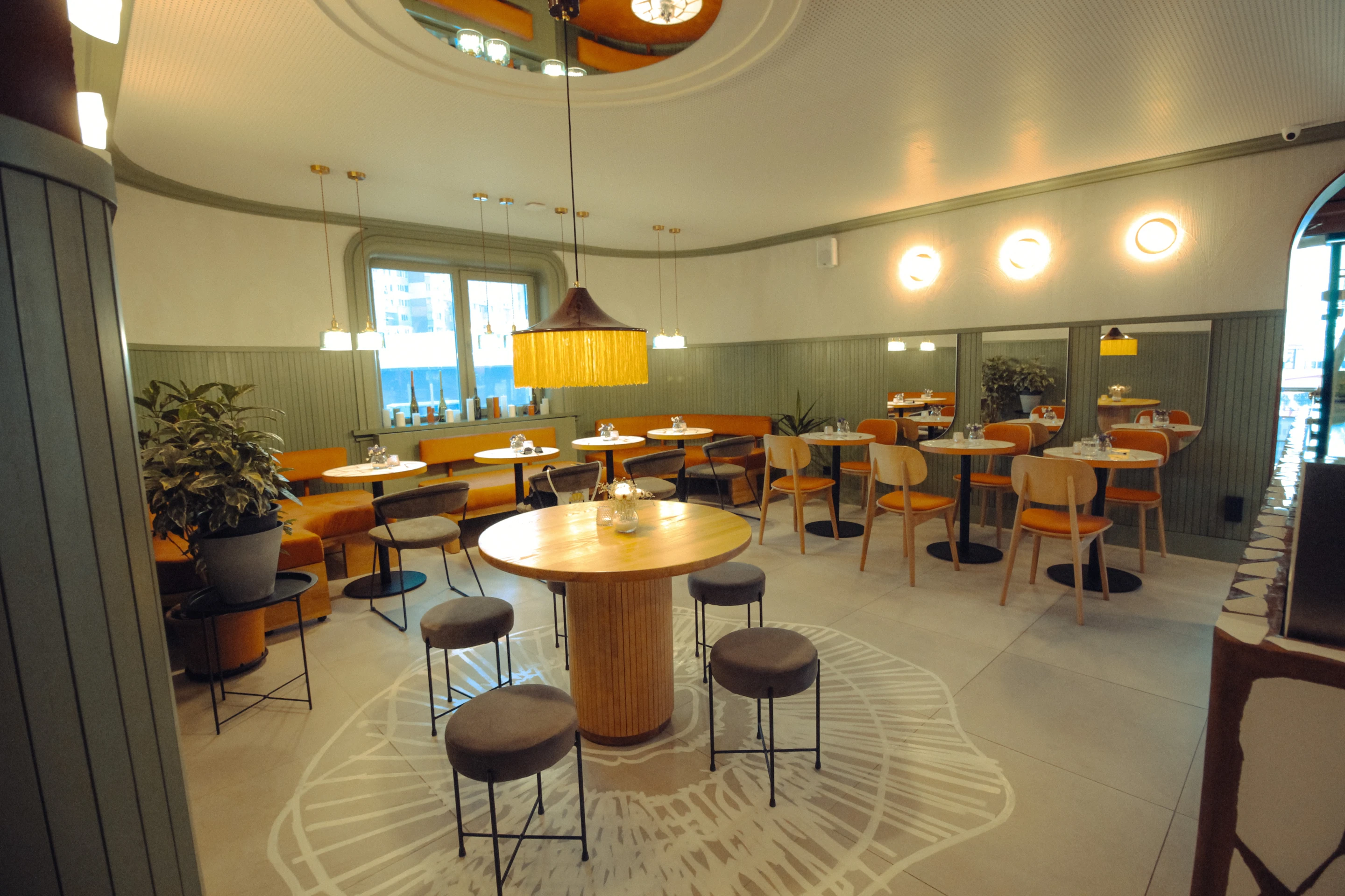 Tartateka: the dining room, counter and central round tables. Completed-interior photograph.