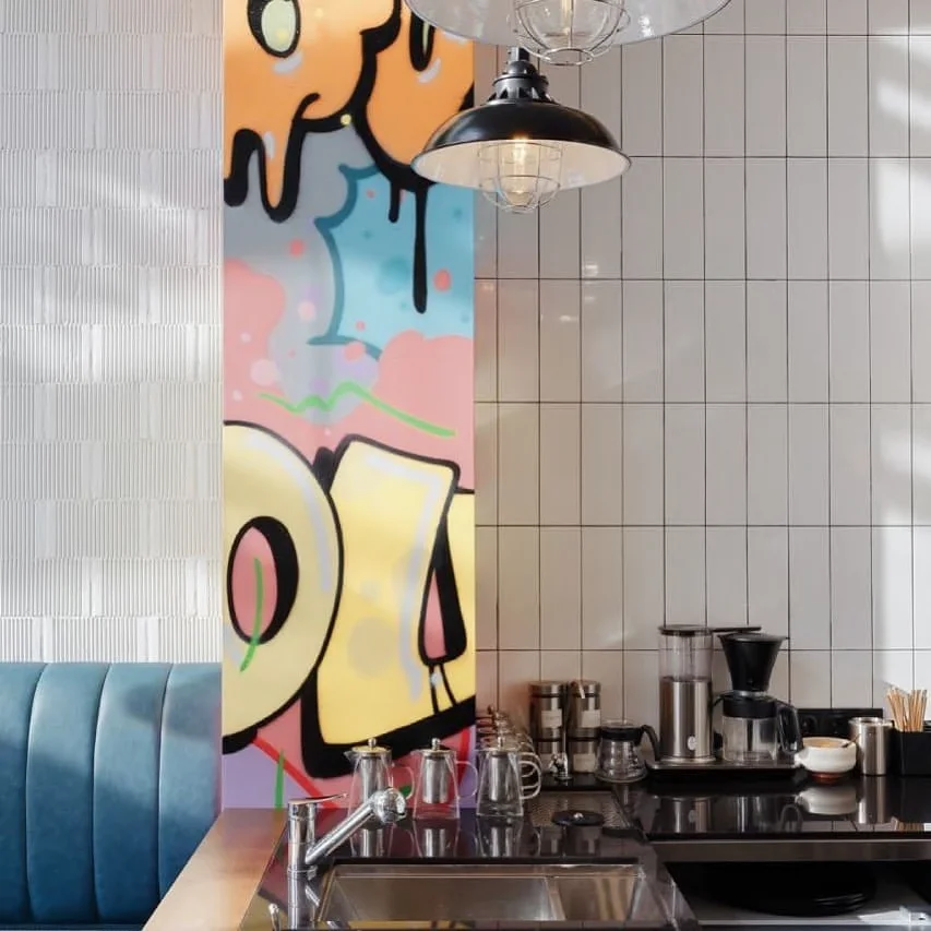 Yourz Bistro: wall artwork above the tiled coffee and service area. Completed-interior photograph.