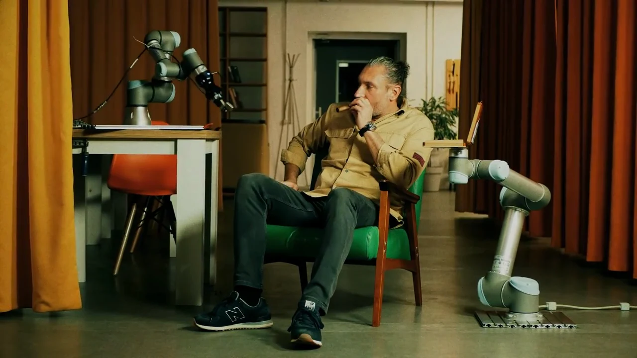 Michael Bagan with a robot at Innovation Kitchen. Frame from the hub’s published short film.