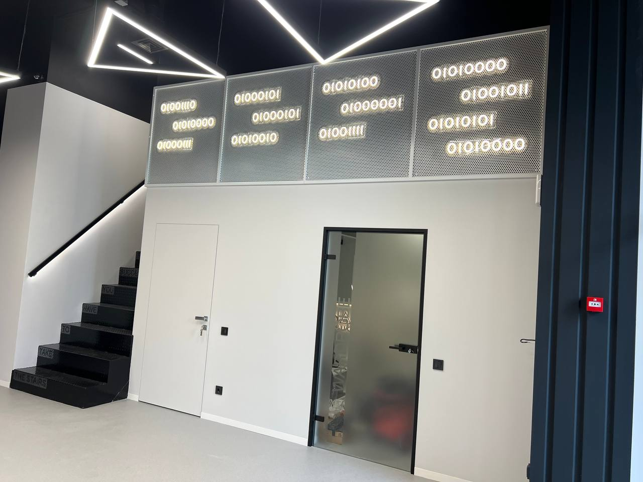 The entrance area and staircase. Netpeak Group Kyiv office. Project archive photograph, received July 2025.