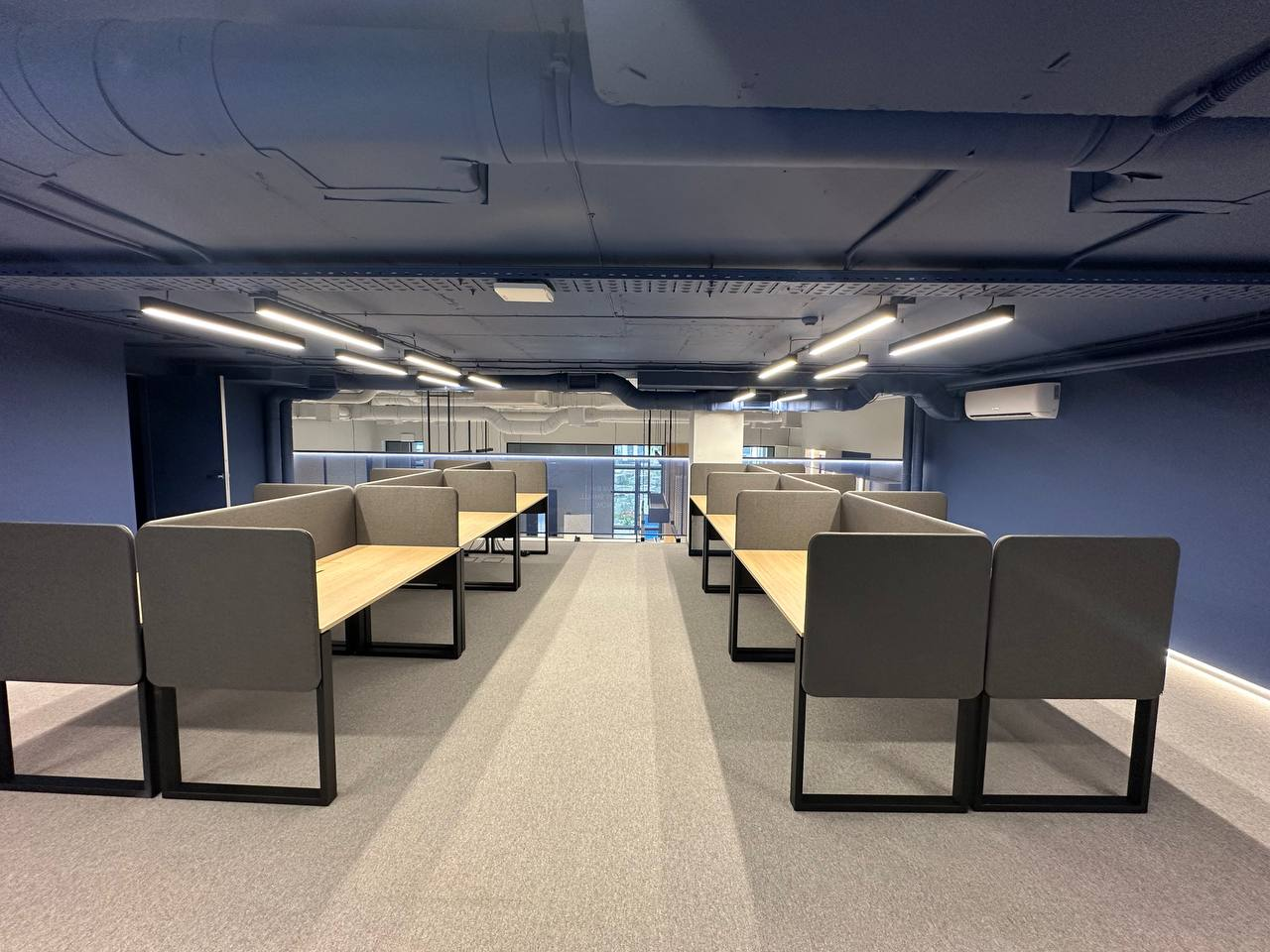 Workstations on the mezzanine. Netpeak Group Kyiv office. Project archive photograph, received July 2025.