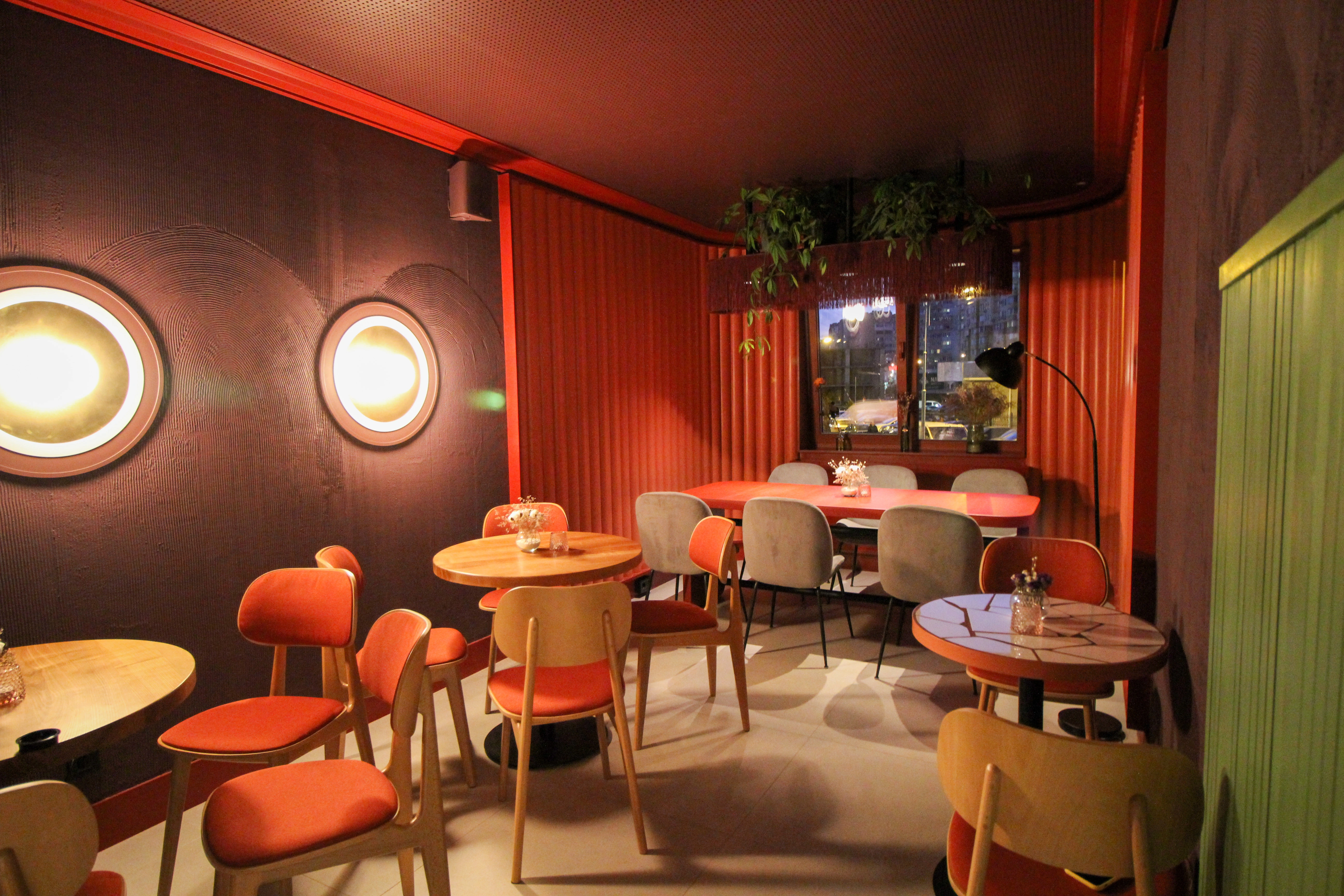 Tartateka — the completed café with round tables and warm lighting, May 2021.